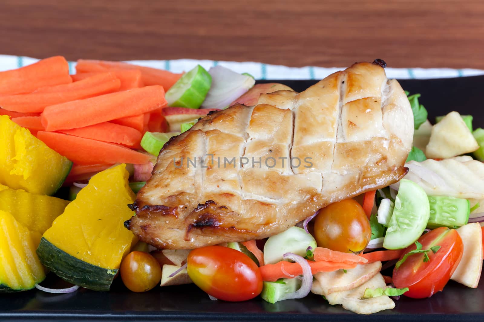 Grilled chicken steak with spices and vegetable on the black dish, Healthy diet meals.