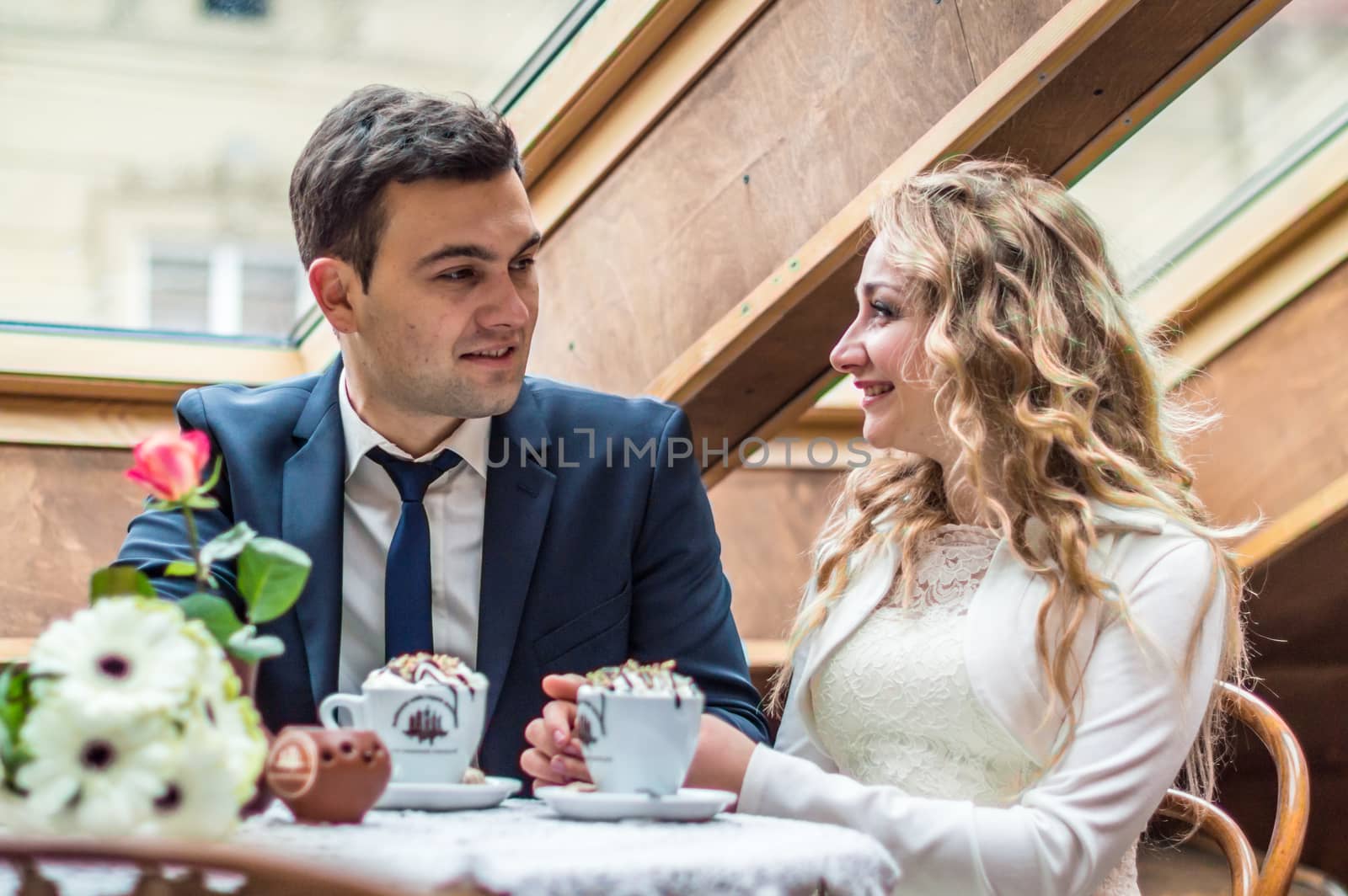 newly married couple drinking coffee in a cafe