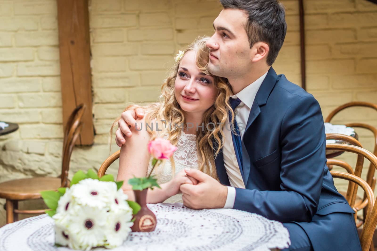 newlyweds sitting in the Cafe at the table