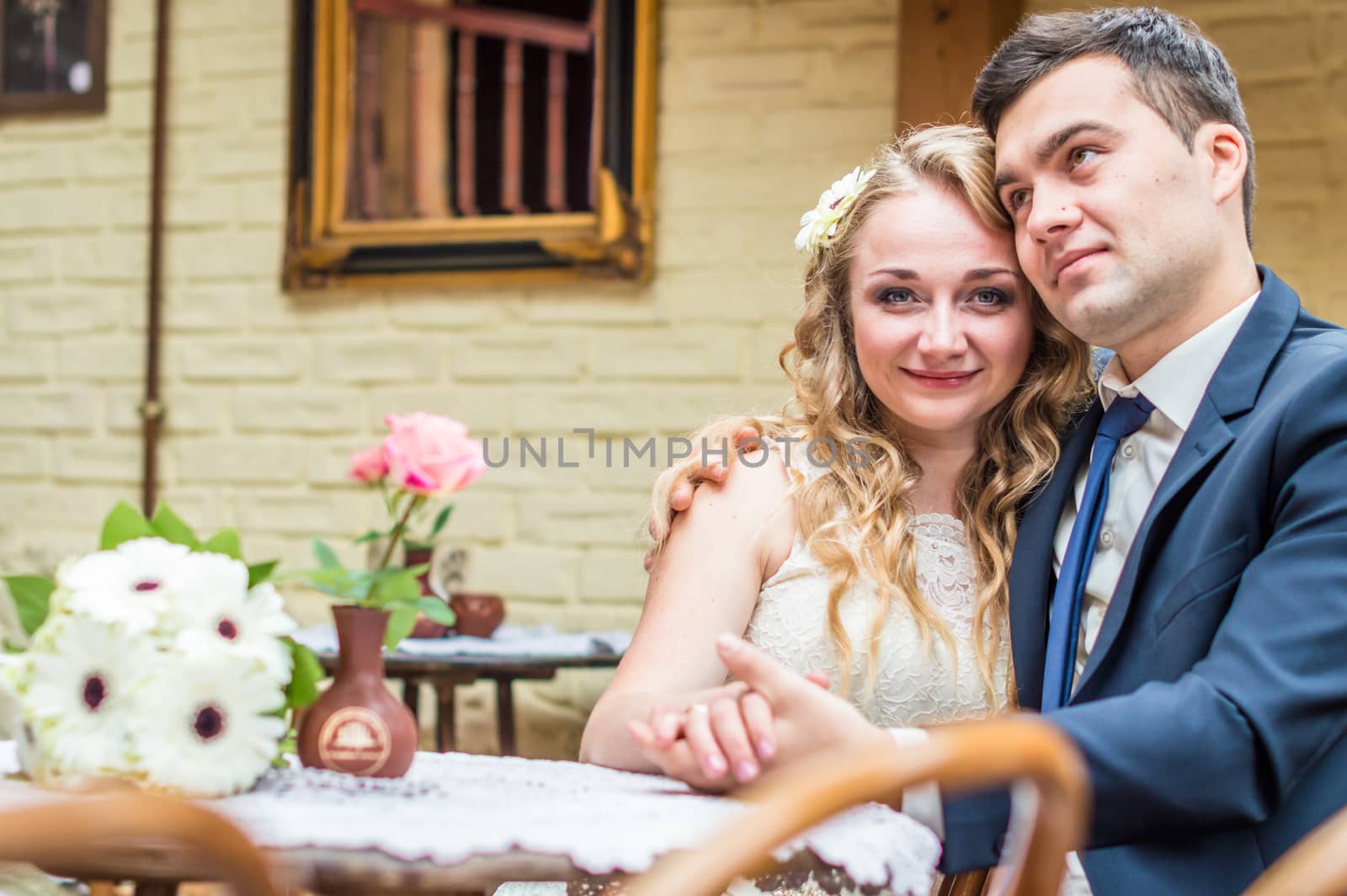 newlyweds sitting in the Cafe at the table