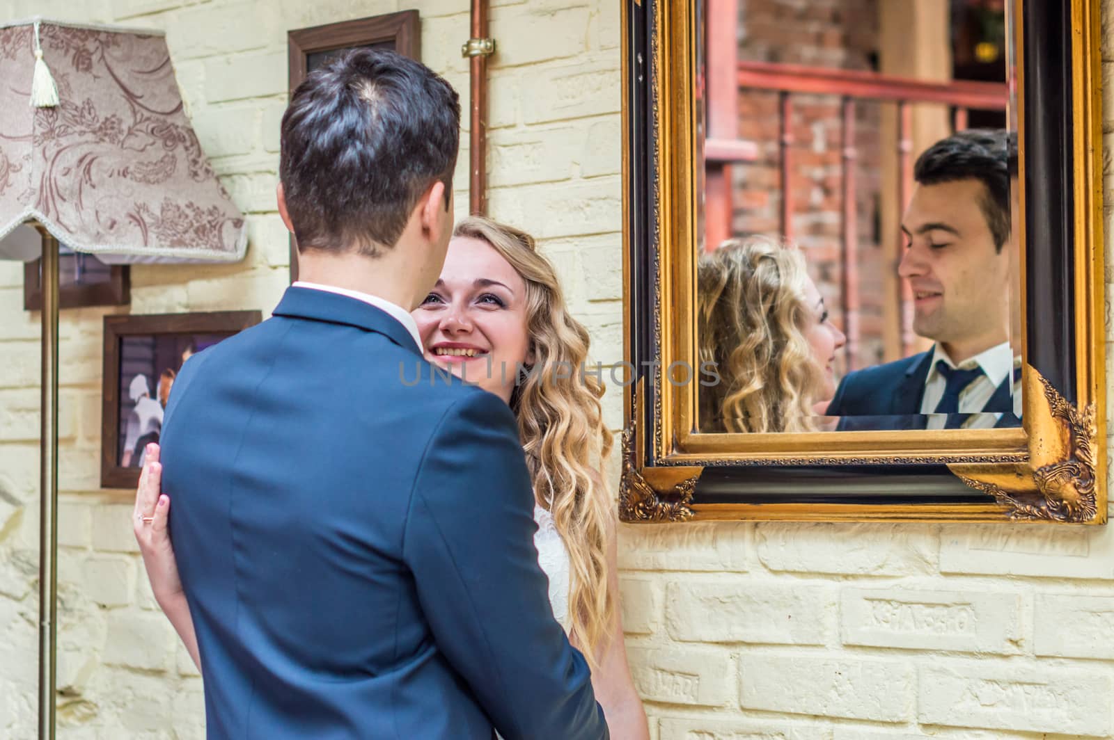 newlyweds near the mirror in the house