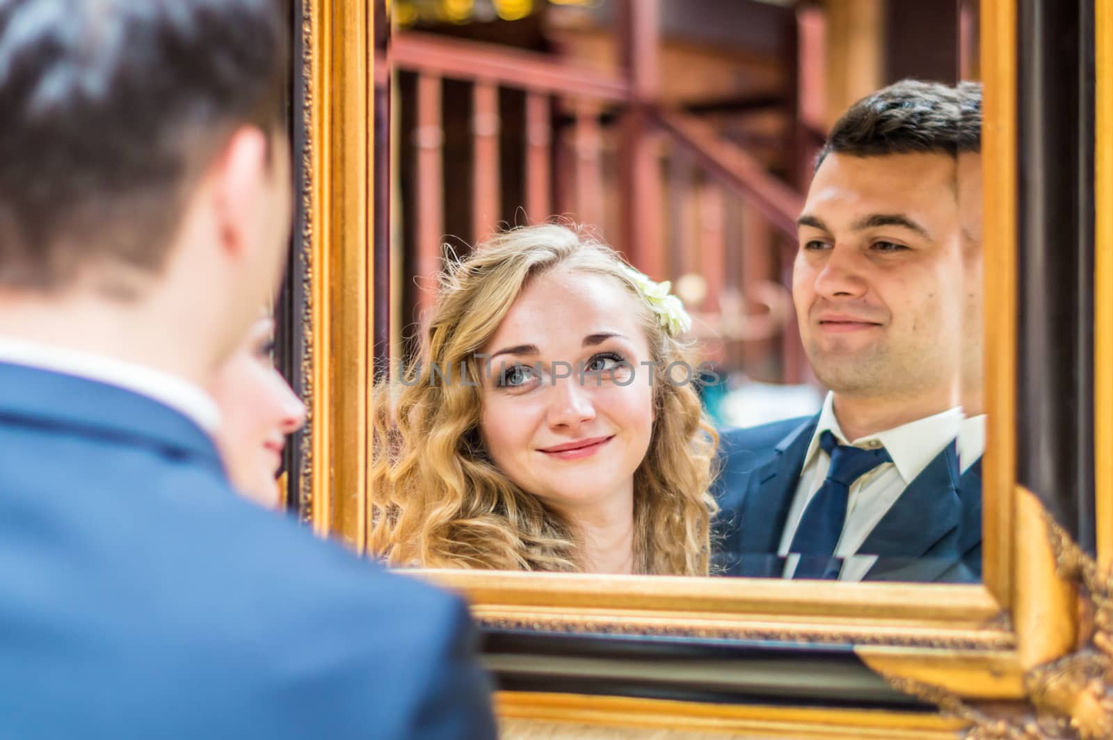 newlyweds near the mirror in the house