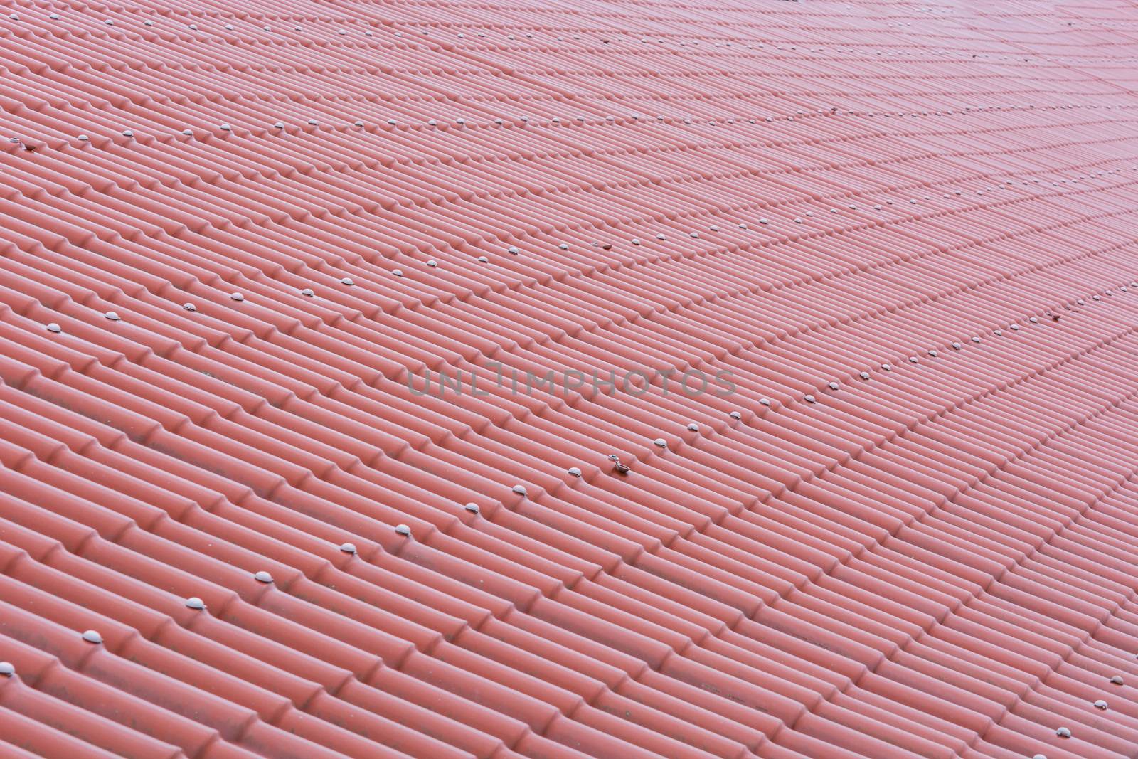 Pattern of a red tile roof of plastic plates.