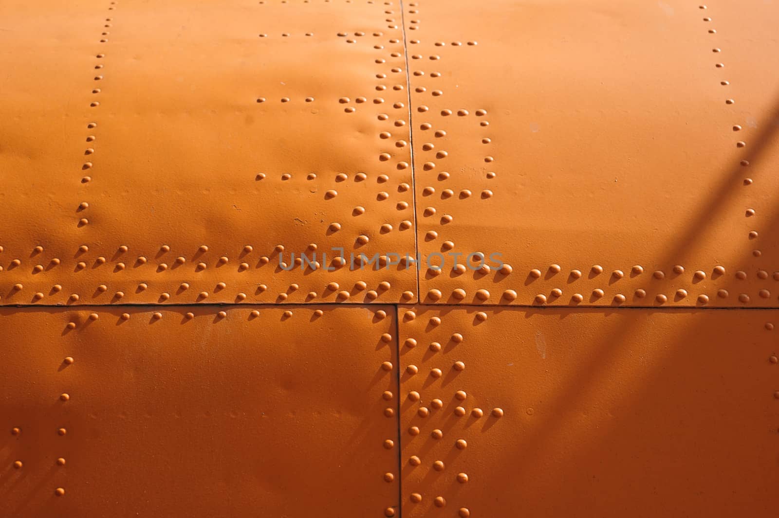 orange texture covering aircraft rivets for background.