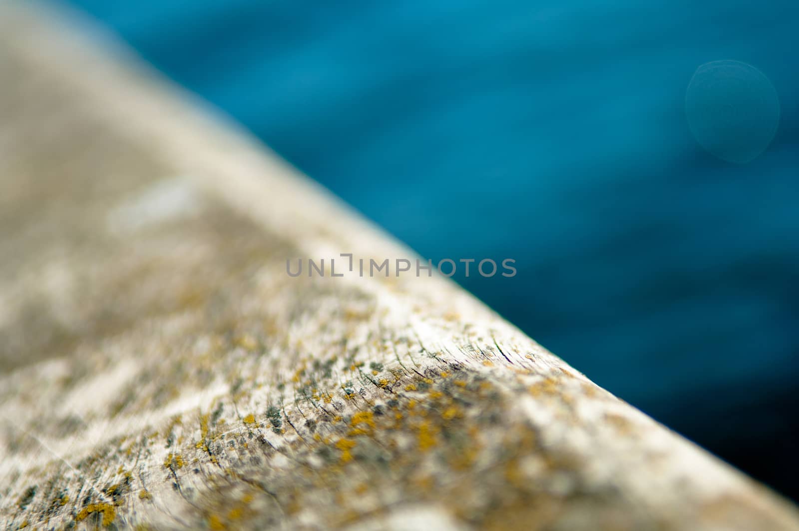 Water and wooden surface divided diagonally, shallow depth of field