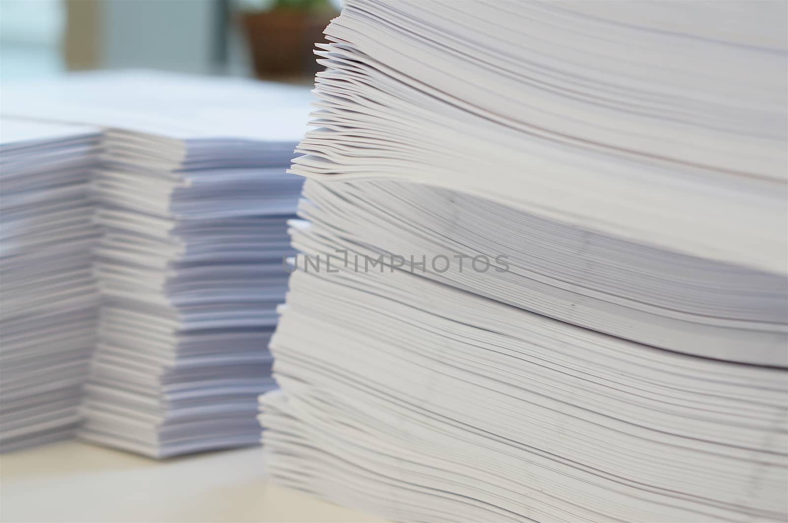 Pile of white papers sheet at office by ninun