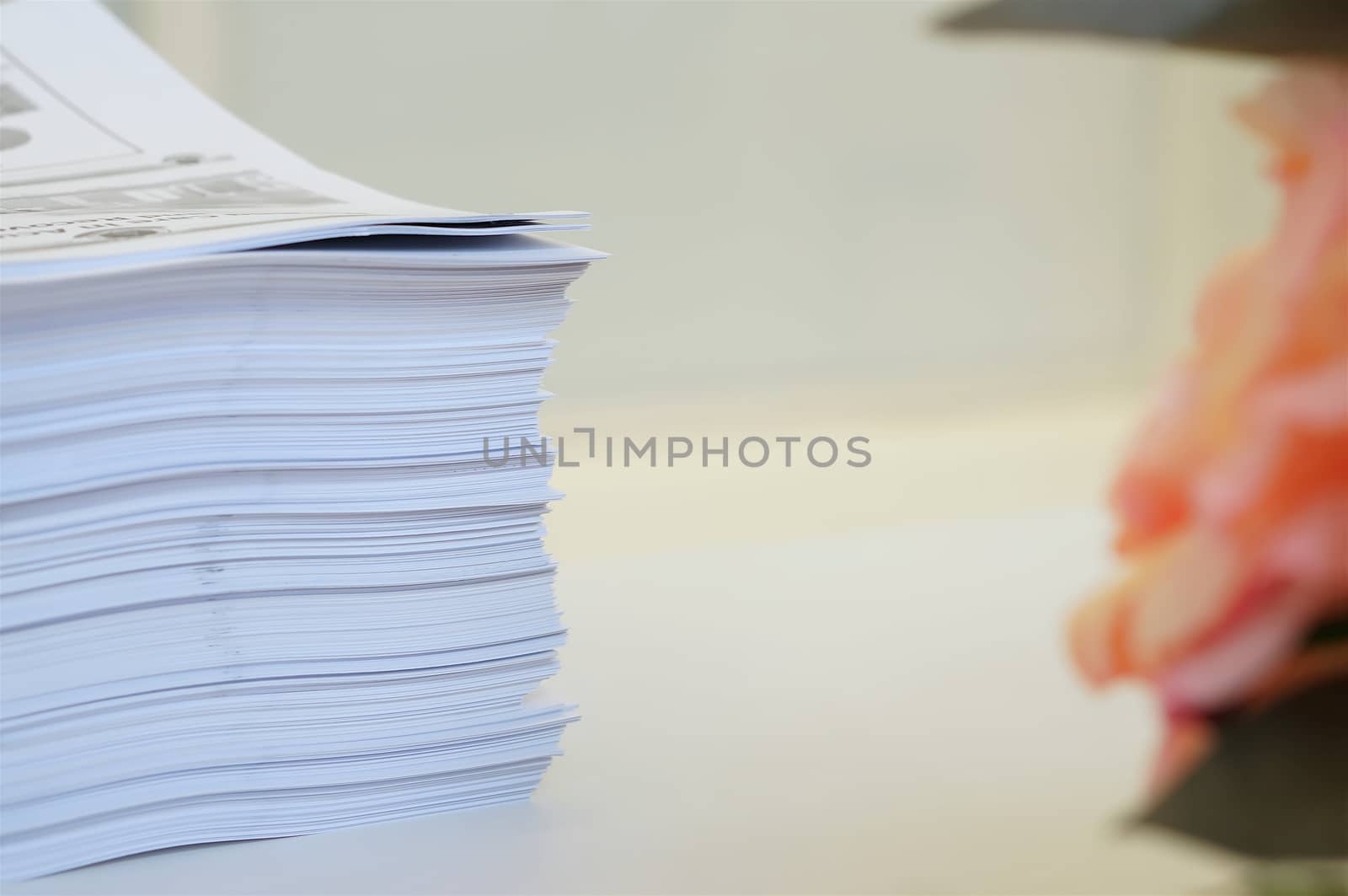 Stack of white papers sheet was organized  on office background by ninun