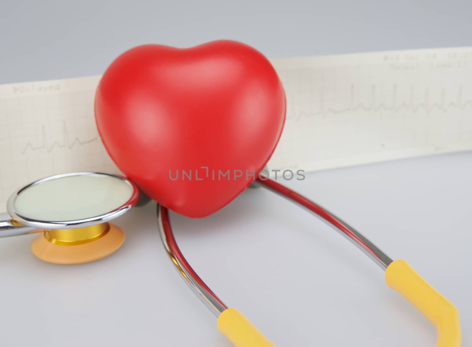 Stethoscope with heart on ECG background by ninun
