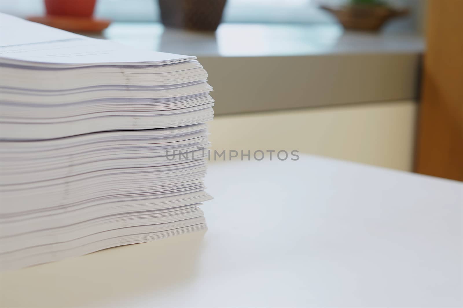 Stack of white papers sheet was organized  on office background.                             
