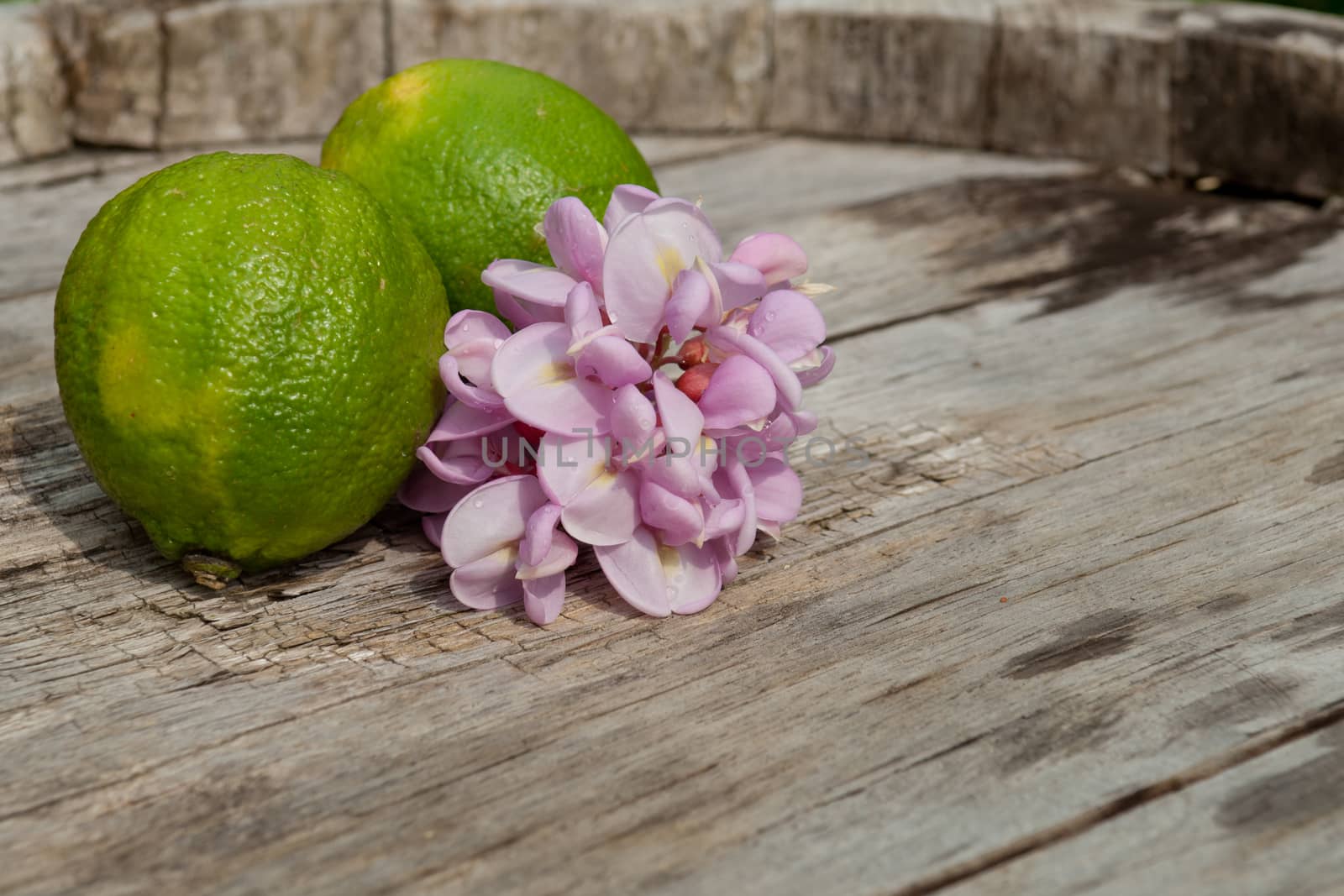 Raw textured wood Background backdrop with lemon and lime and copy space outdoor