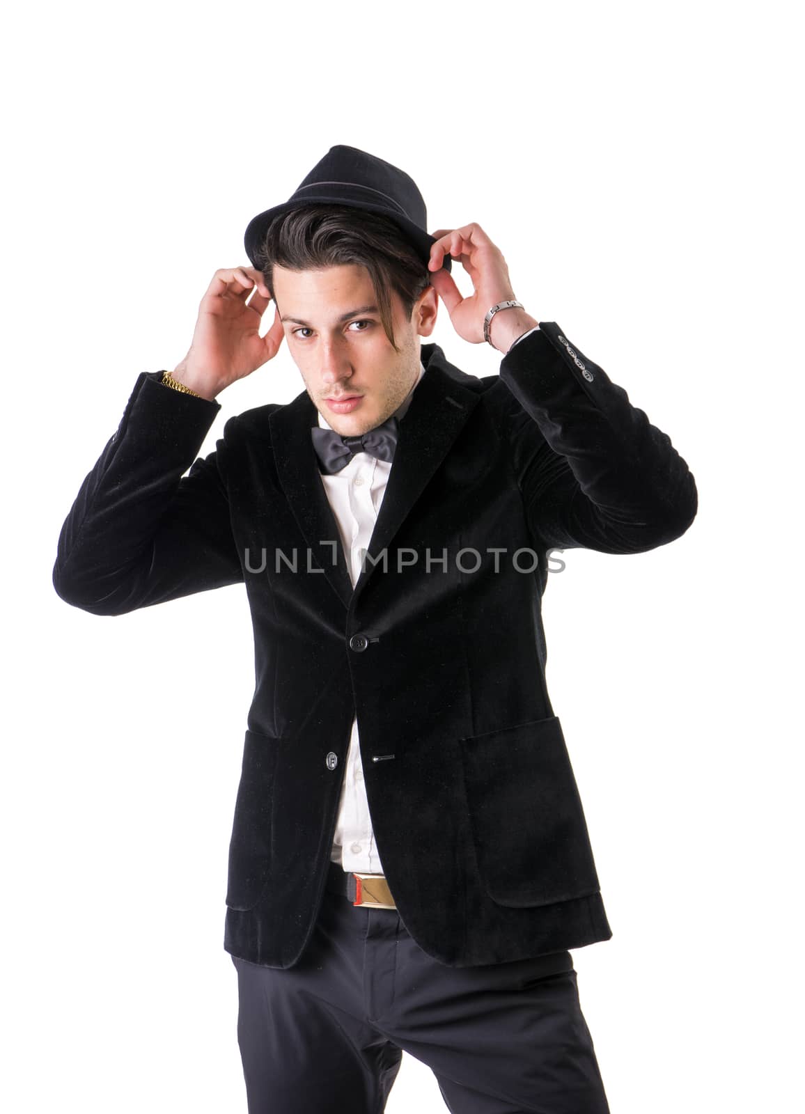 Young businessman confidently posing and looking at camera, wearing suit isolated on white background