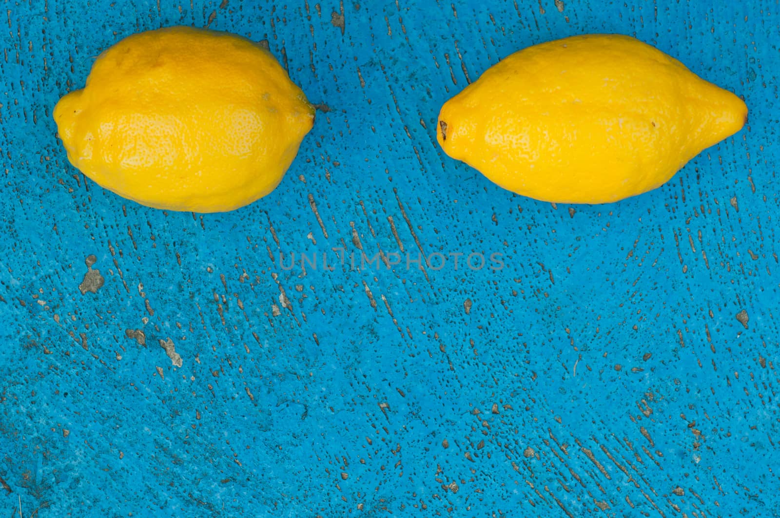 Old light blue textured background with lemons turquoise background scratched surface