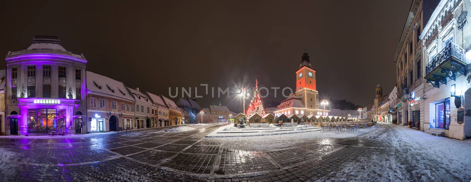 BRASOV, ROMANIA - 15 DECEMBER 2016: Brasov Council House panoramic night view with Christmas Tree decorated and traditional winter market in the old town center, Romania