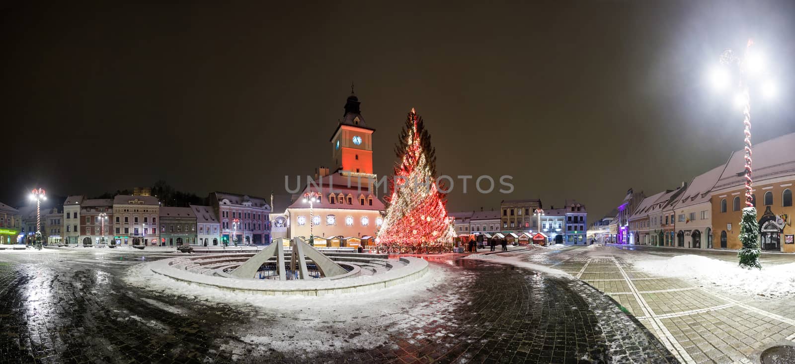 BRASOV, ROMANIA - 15 DECEMBER 2016: Brasov Council House panoramic night view with Christmas Tree decorated and traditional winter market in the old town center, Romania