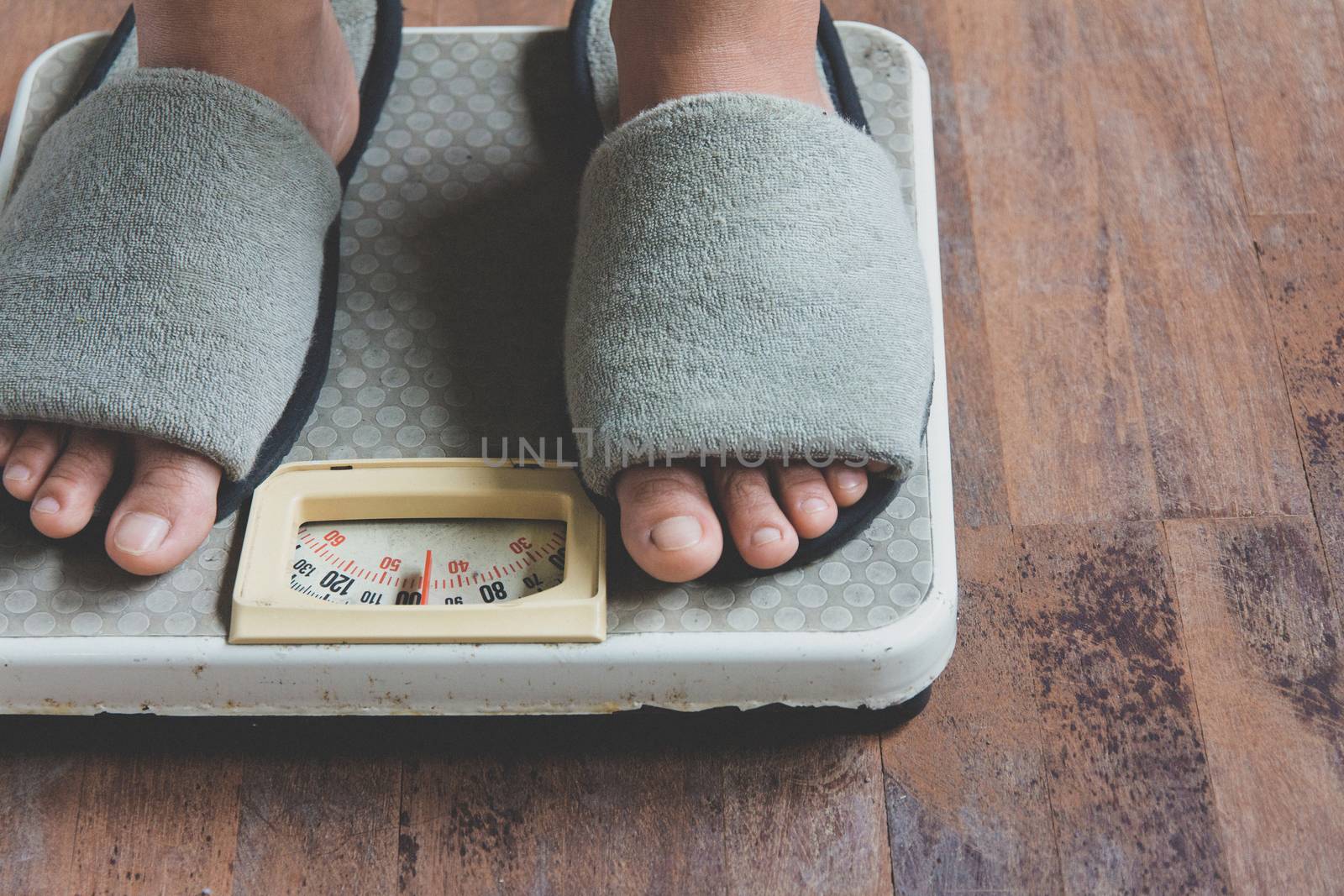 image of woman standing on weighing scale