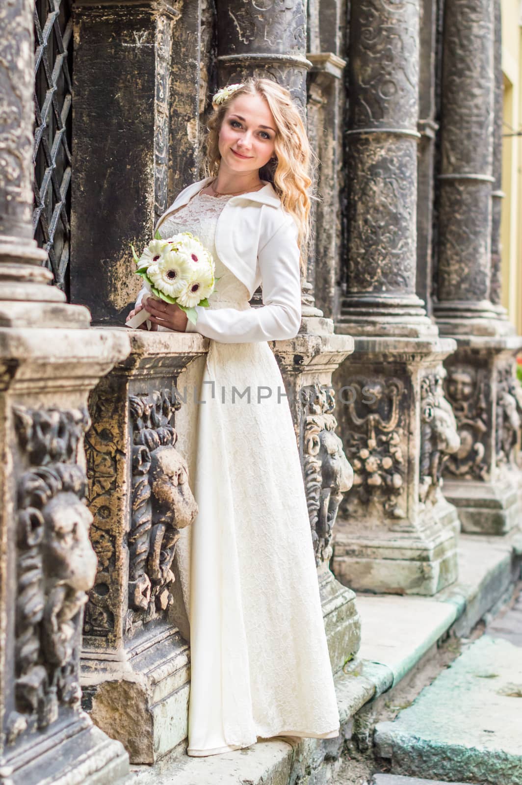 Portrait of a bride in a white dress in the city