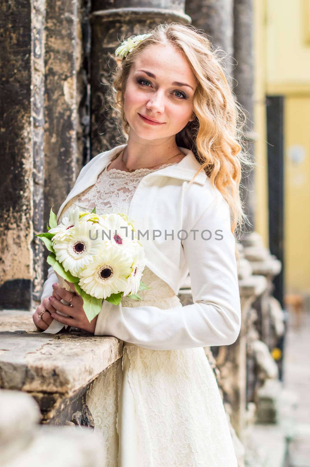 Portrait of a bride in a white dress in the city