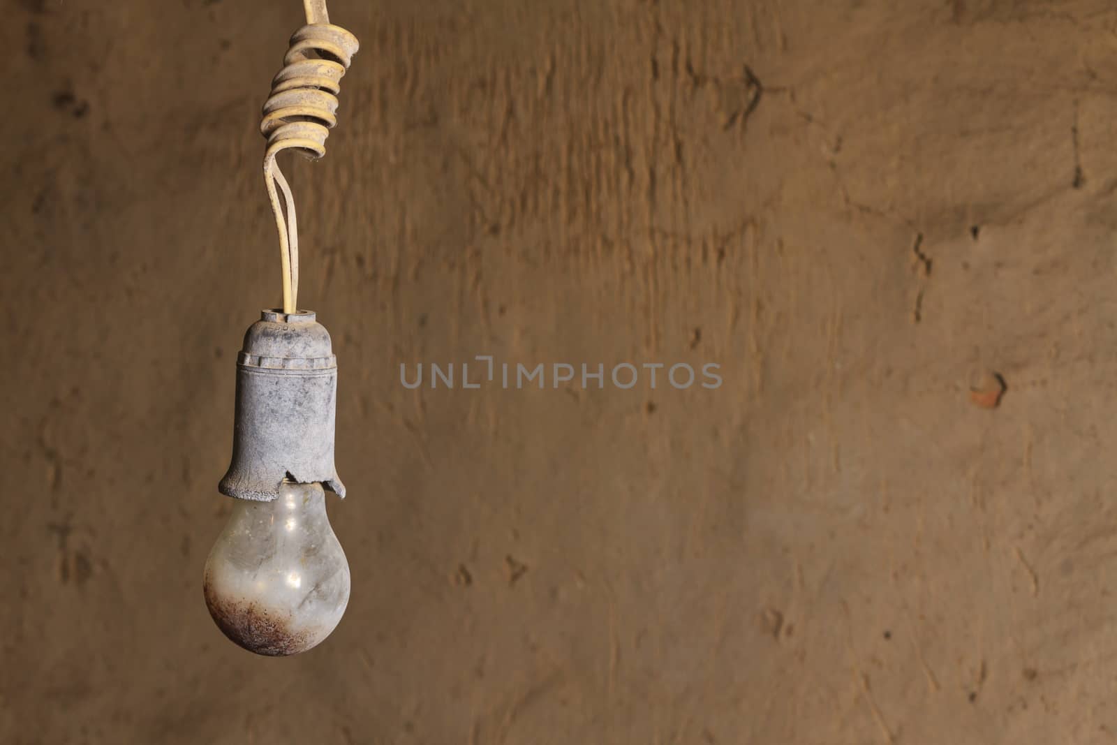 old burnt bulb against a background cracked wall,Breakage, old, decay,abandoned house