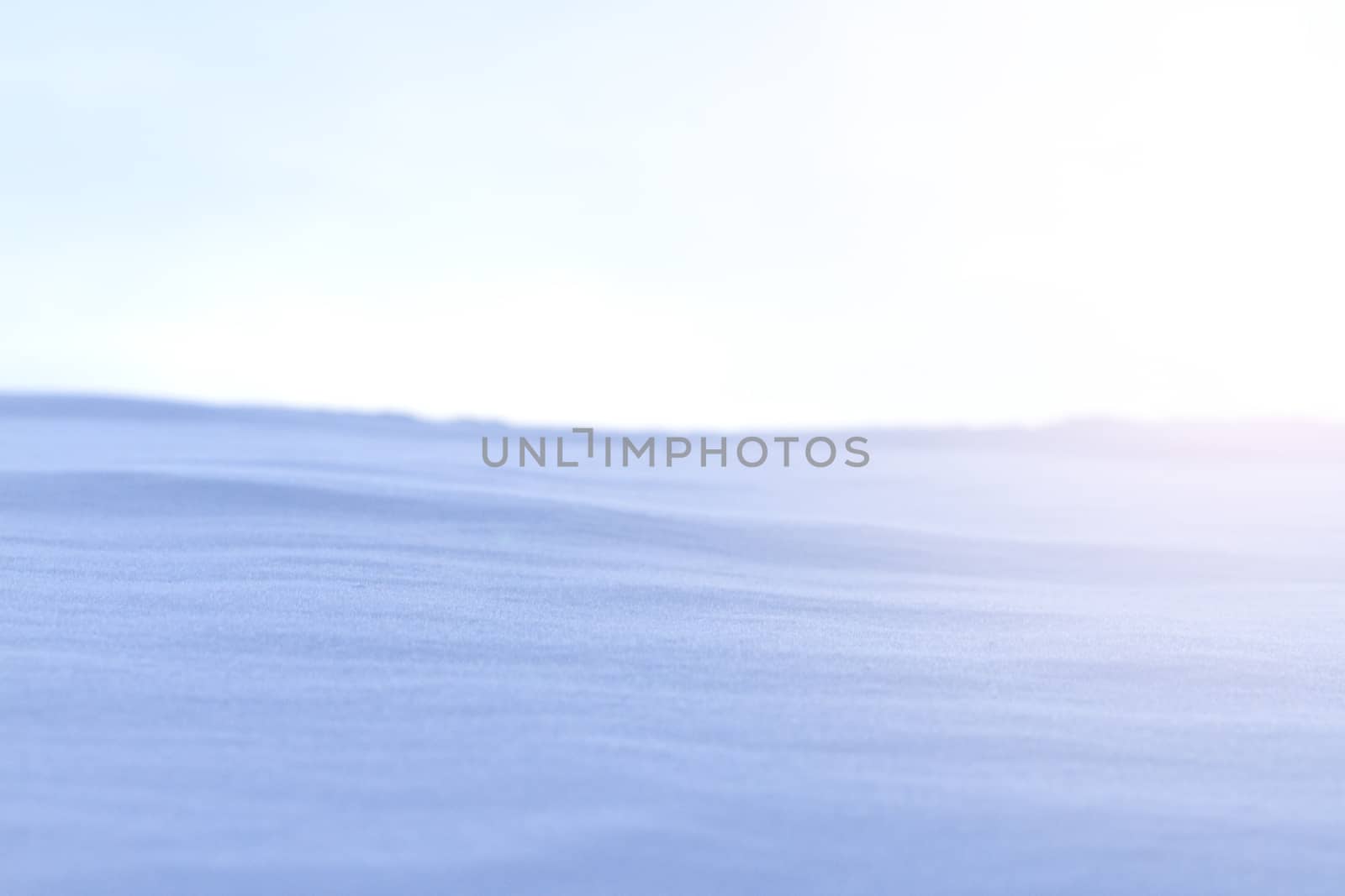 snow drifts and gray sky with sunny hotspot,Winter frost and snow