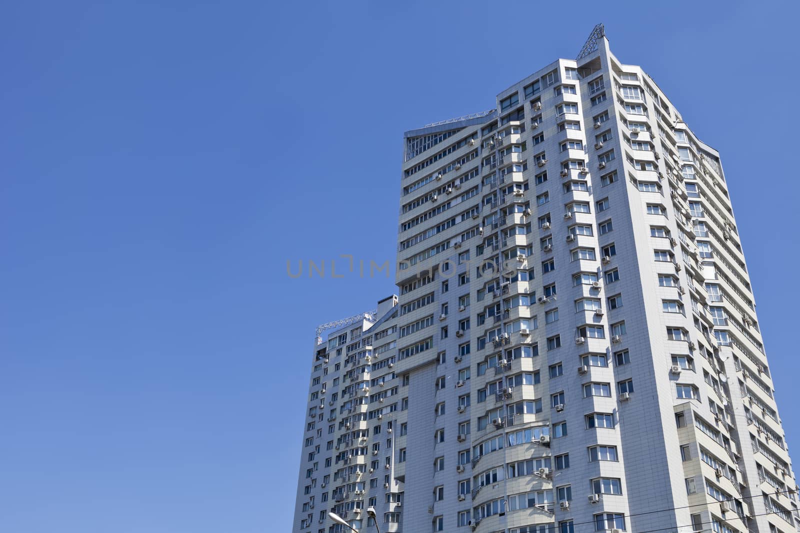 Real estate. Large multi-storey building on a blue sky