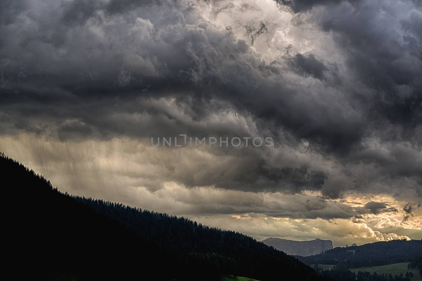 Thunderstorm over the Gardena Valley with Seiser Alm at the horizon at the sunset, Trentino-Alto Adige