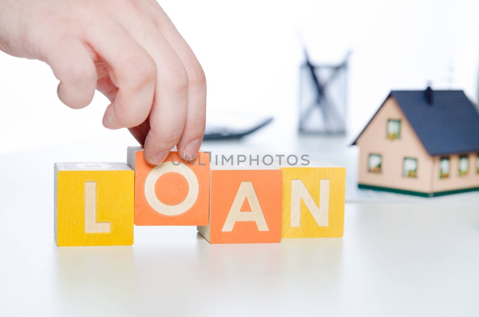 LOAN word with colorful blocks. loan word debt forecasting money financial cube repaying concept