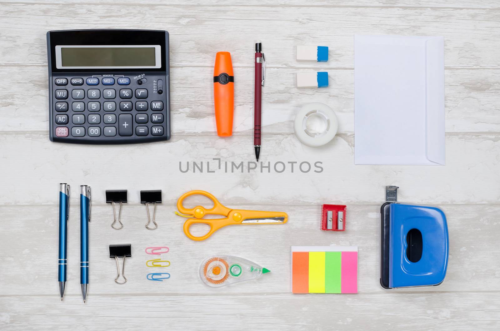 Business desk in office top view. Table with calculator, notepad, and office supplies arranged in perfect order