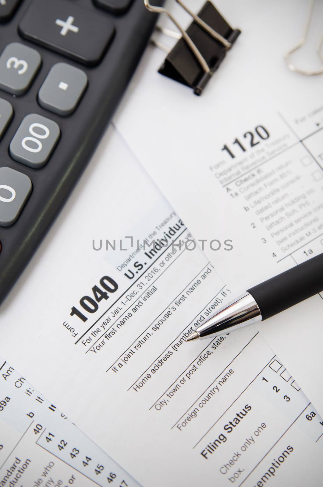 US tax form 1040 with pen and calculator by simpson33