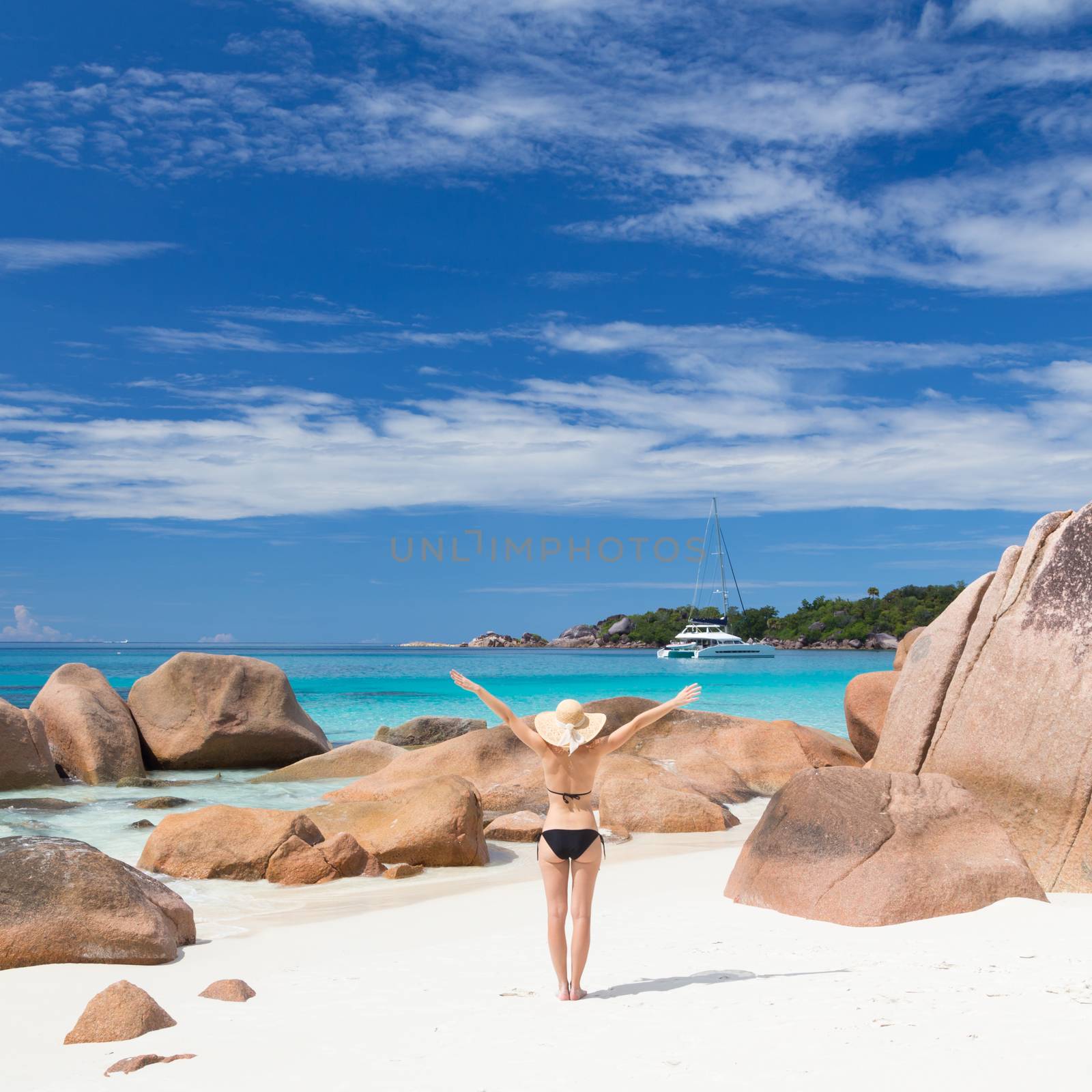 Woman enjoying Anse Lazio picture perfect beach on Praslin Island, Seychelles. by kasto