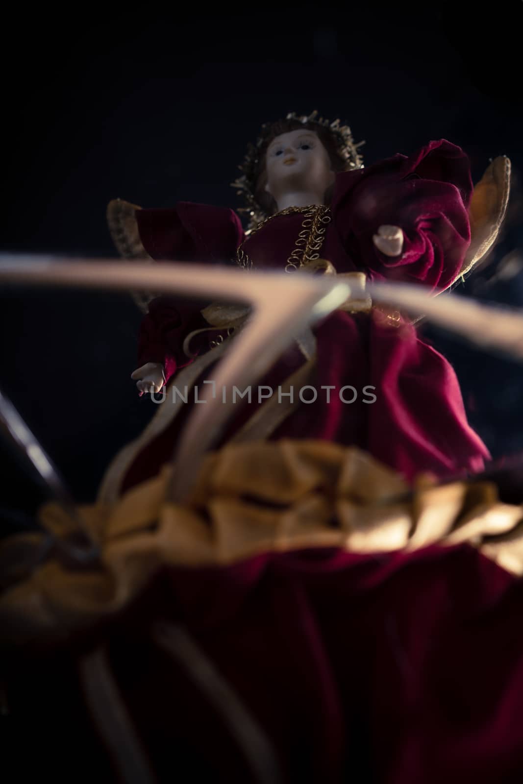 Antique porcelain angel doll on cracked mirror