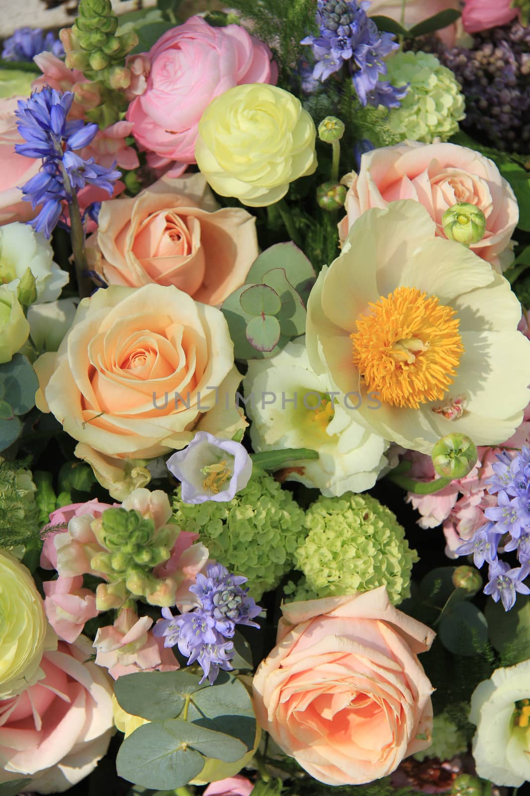 Mixed bridal flower decorations: peonies, ranunculus and roses in pastel colors