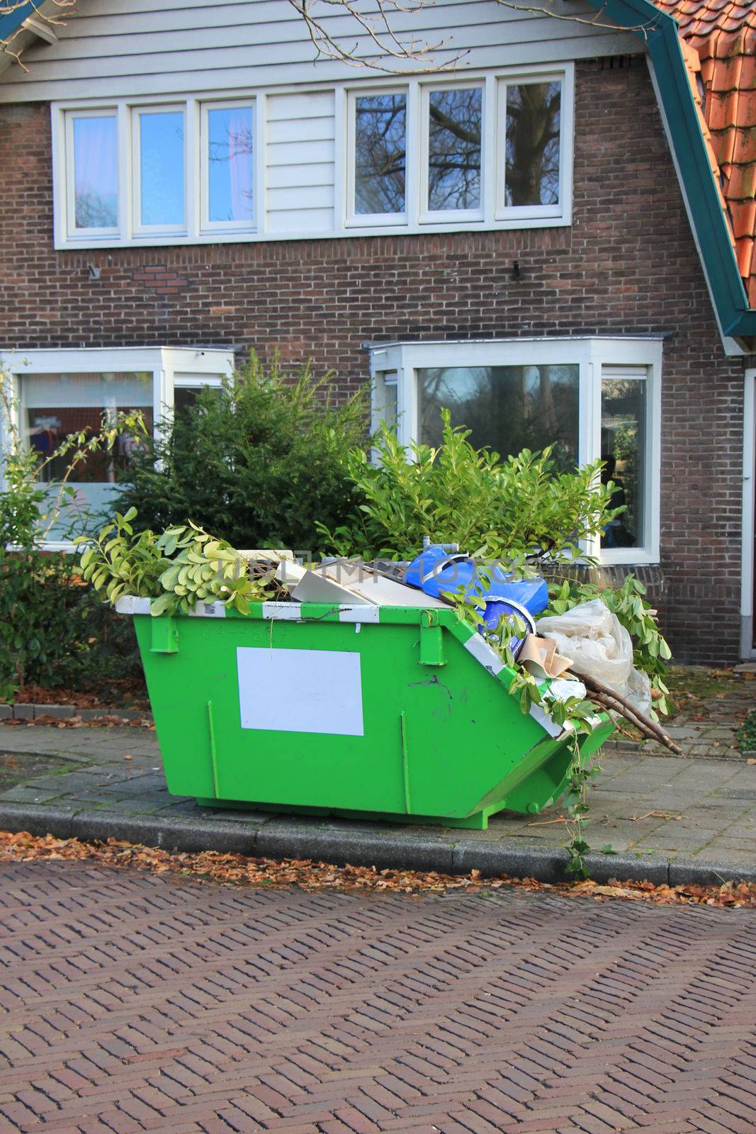 Loaded dumpster near a construction site, home renovation