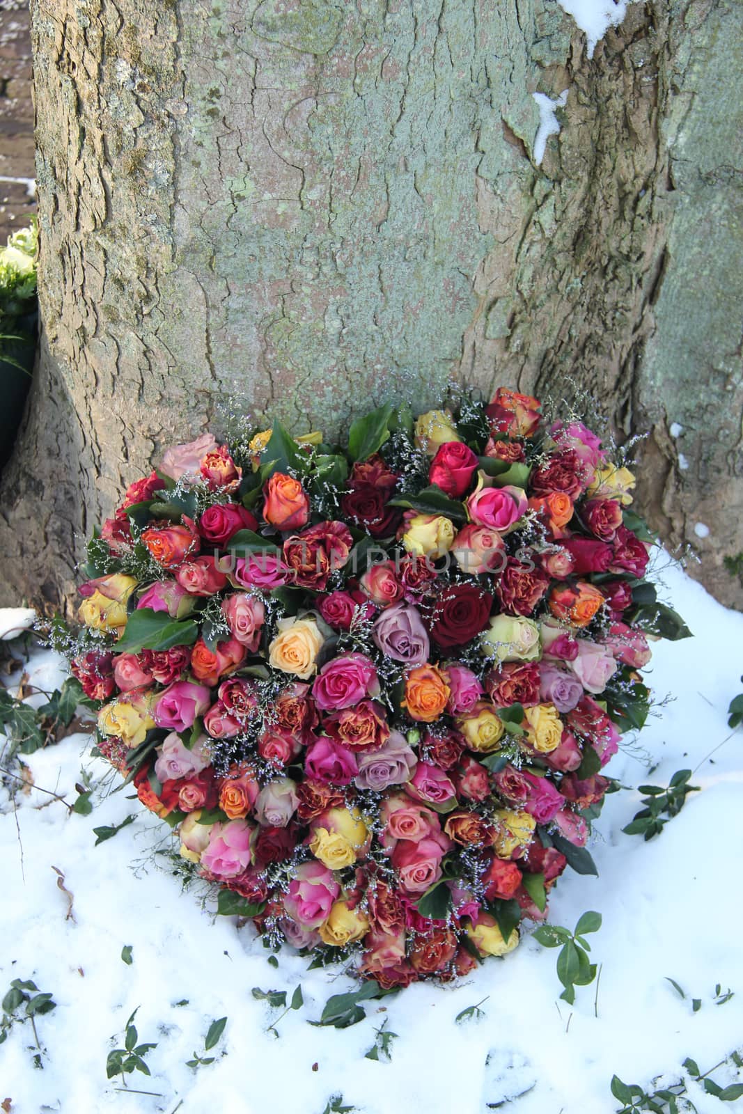 Heart shaped sympathy flowers in the snow