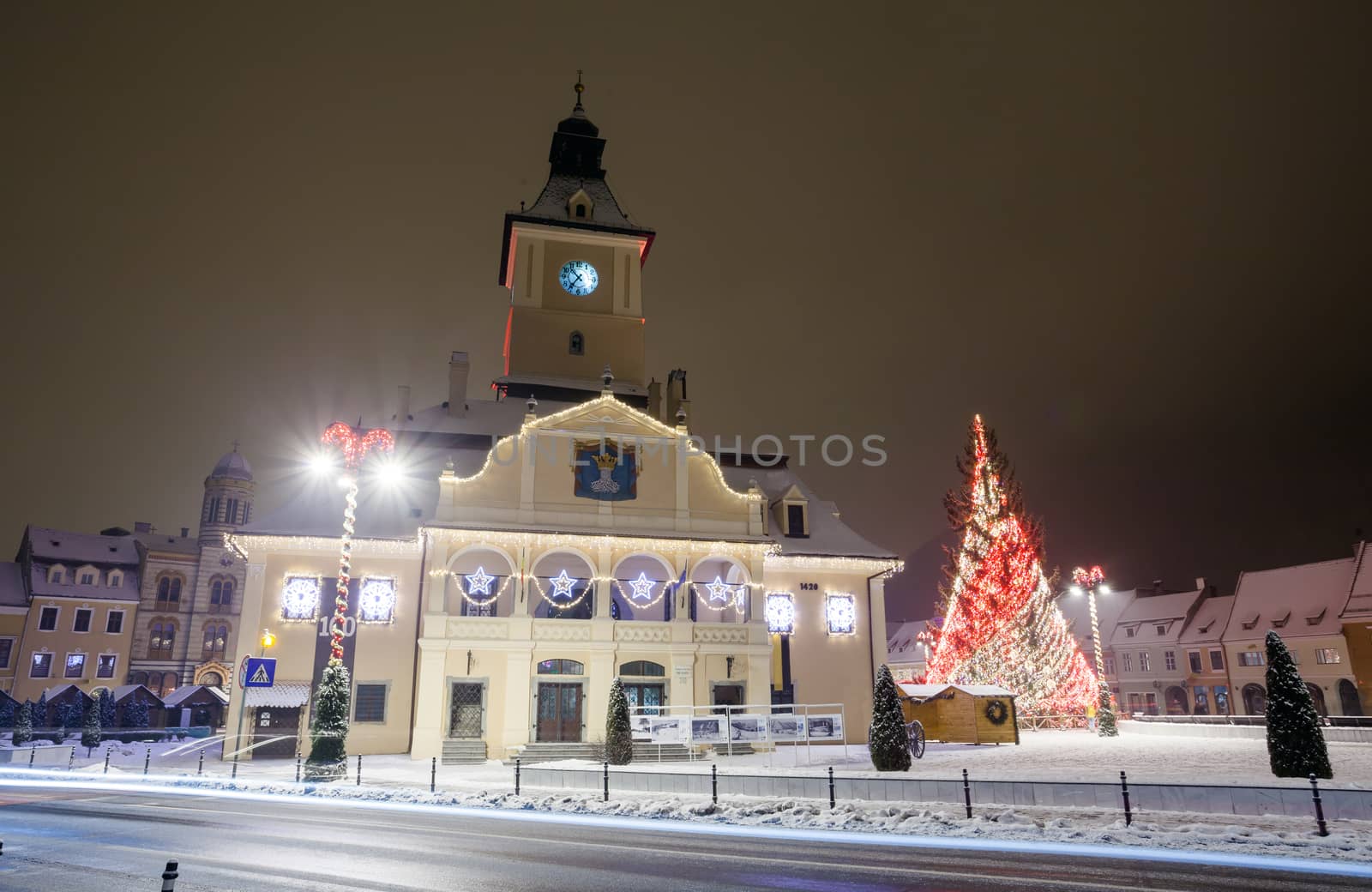 Brasov Council House night view with Christmas Tree decorated and traditional winter market in the old town center, Romania