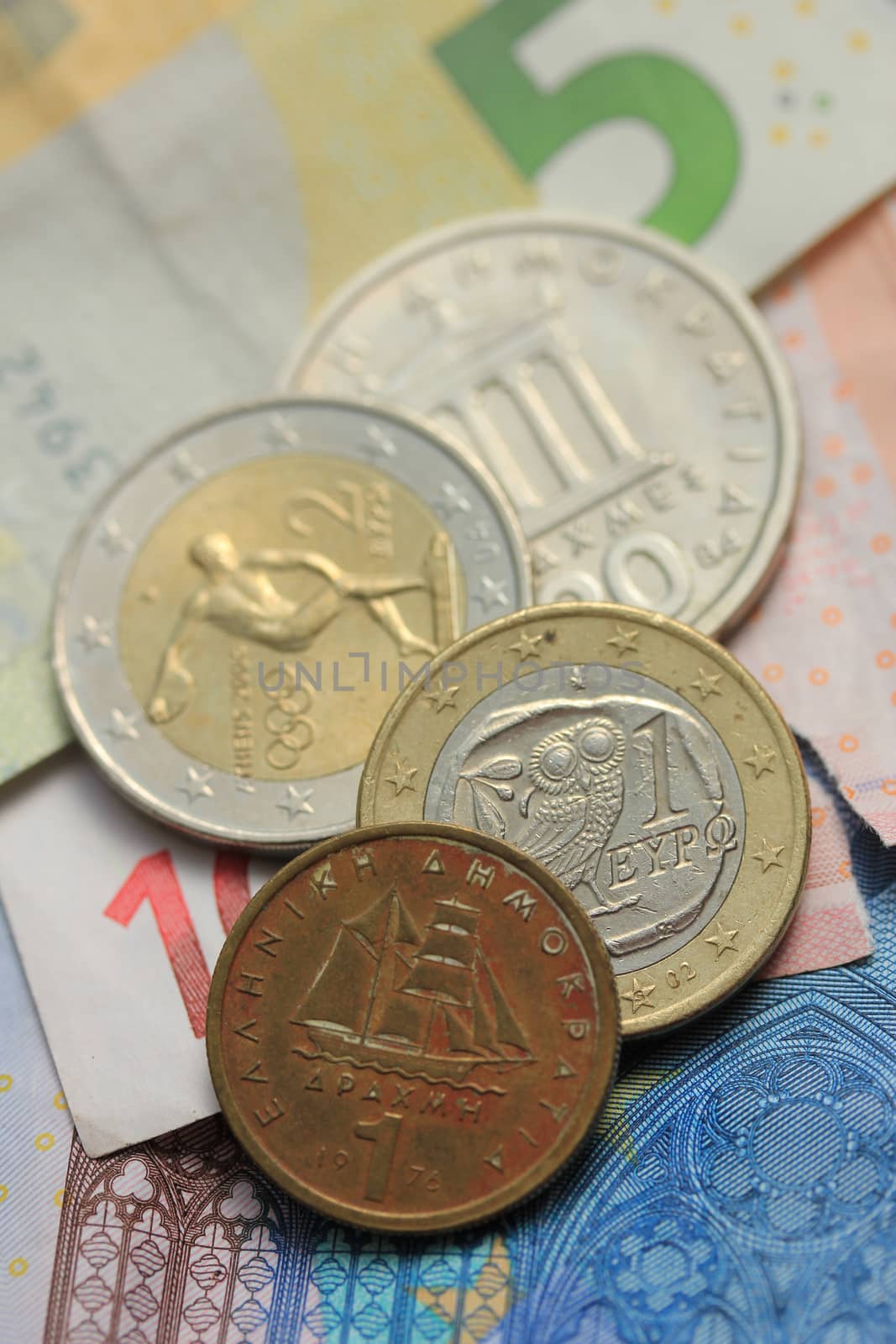 Old Greek and modern greek euro coins on Euro bank notes