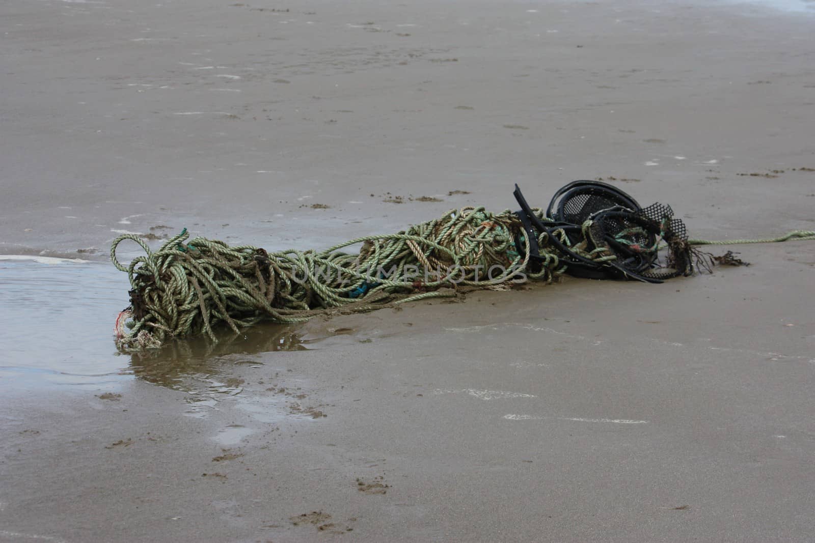 old rope abandoned on a sandy beach