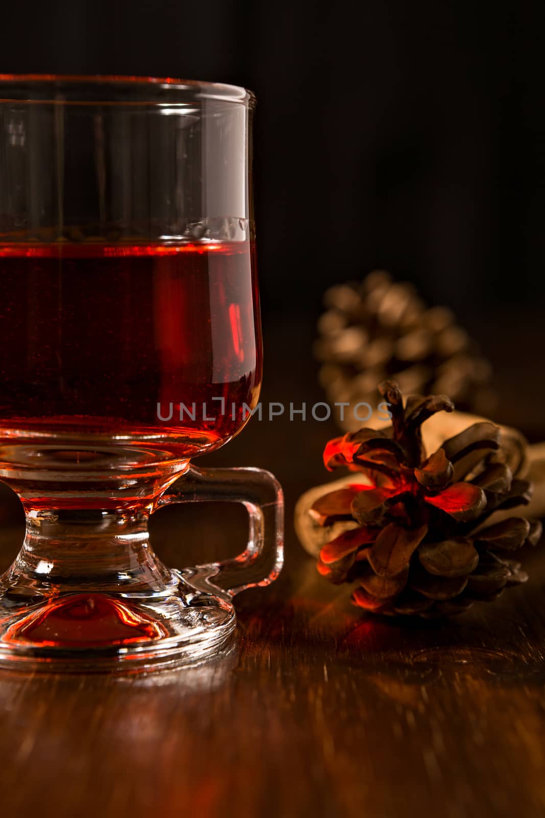 Closeup of alcoholic punch drink and pine cone
