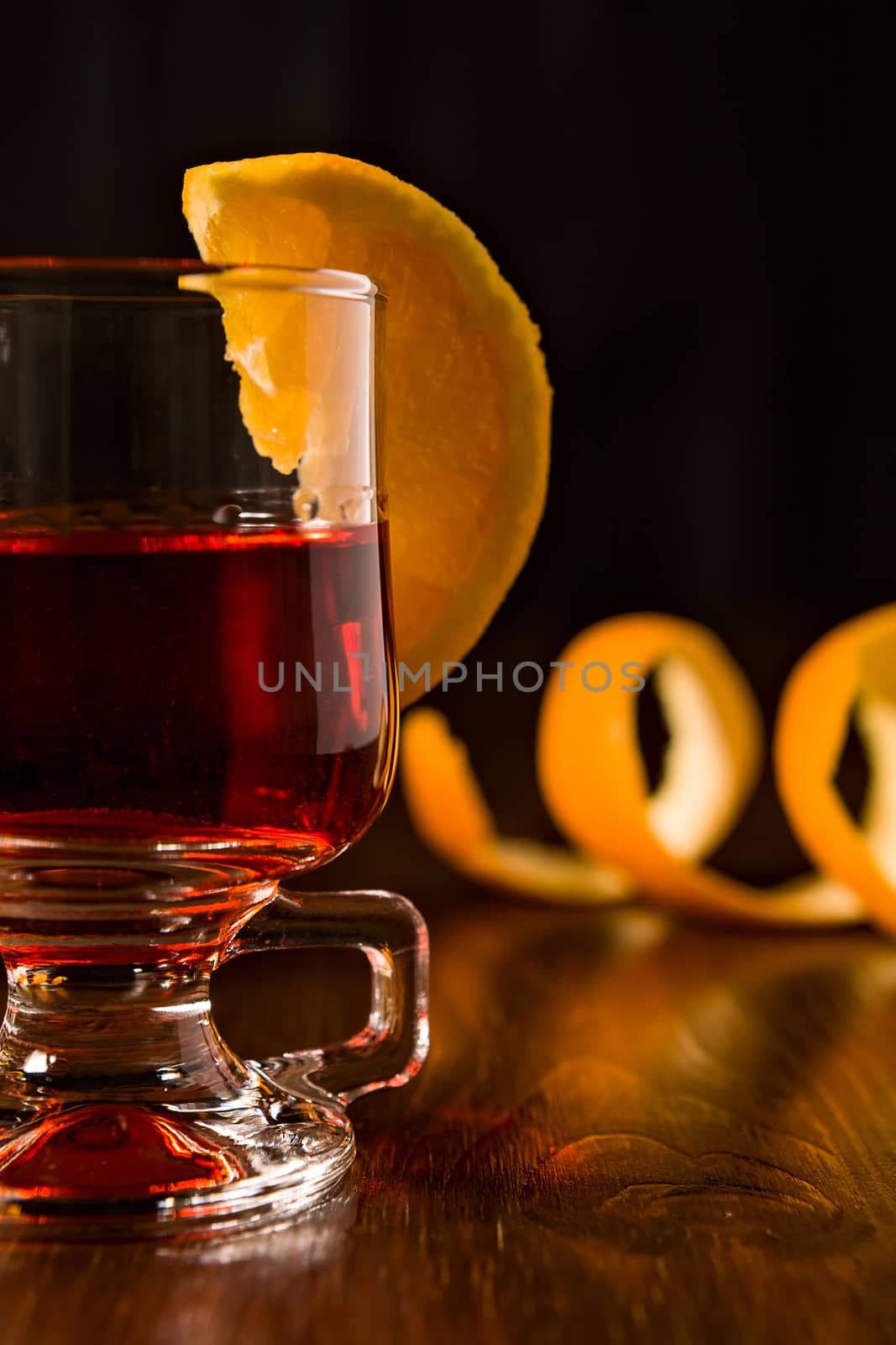 Closeup of alcoholic punch drink and sliced orange fruit