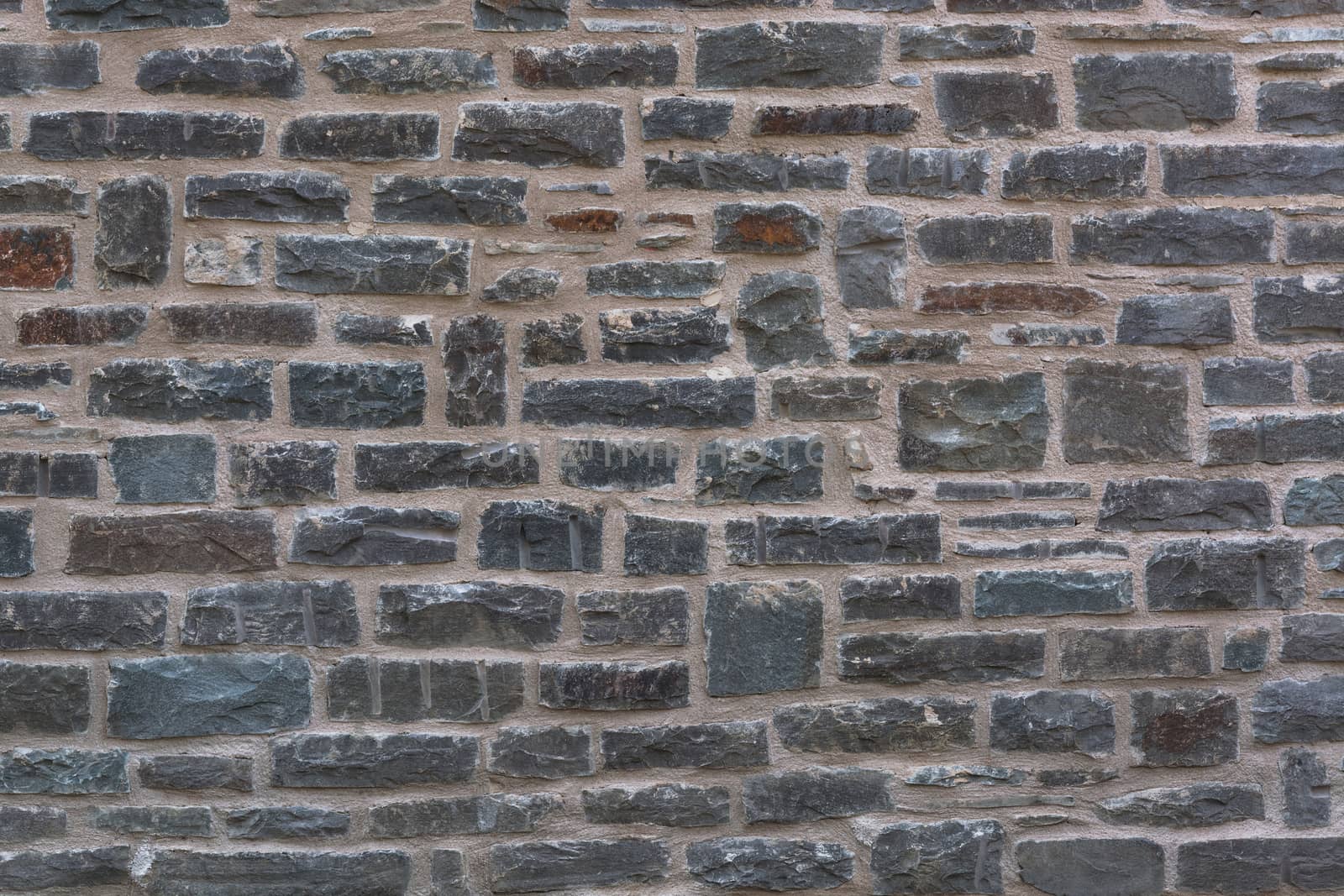 Background, old broken stone wall with relief texture and shadows.