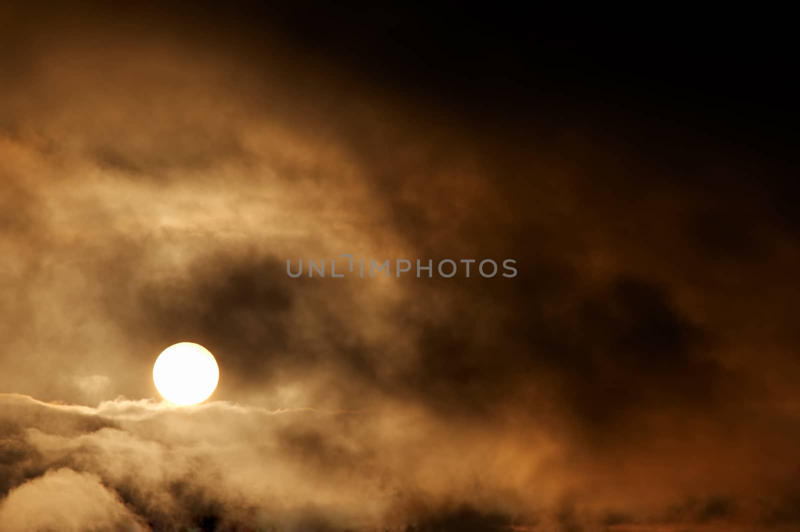 Abstract image of the dark storm clouds and setting sun