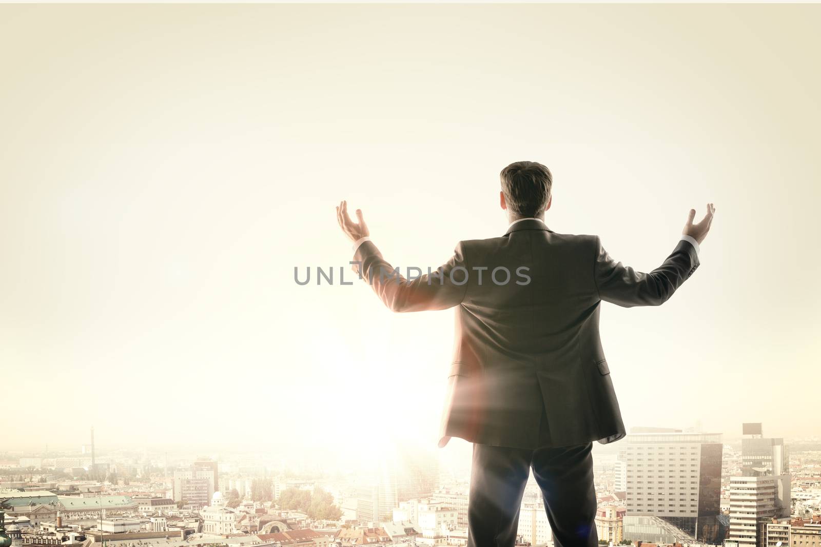 Happy businessman looks sunrise in city, concept for business