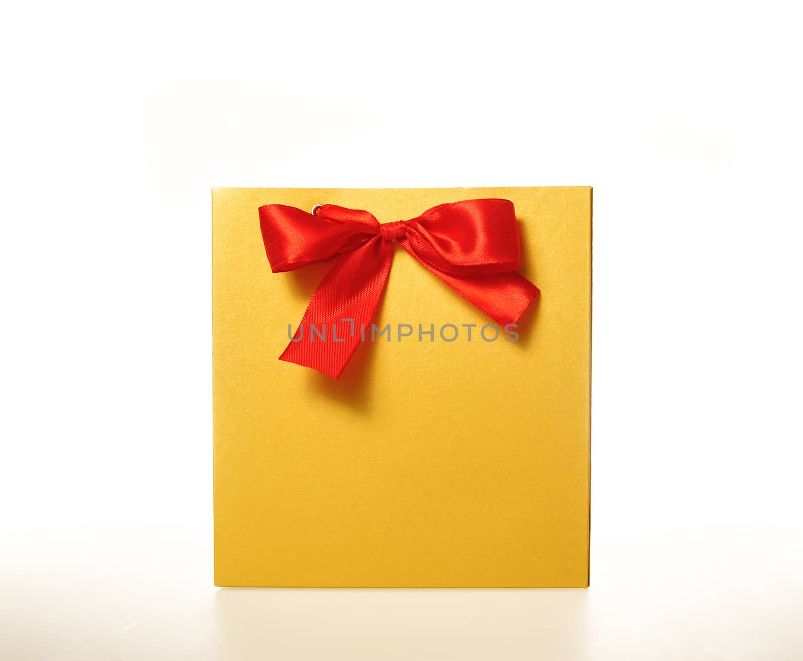 yellow paper gift bag with a Red Ribbon on a white background.