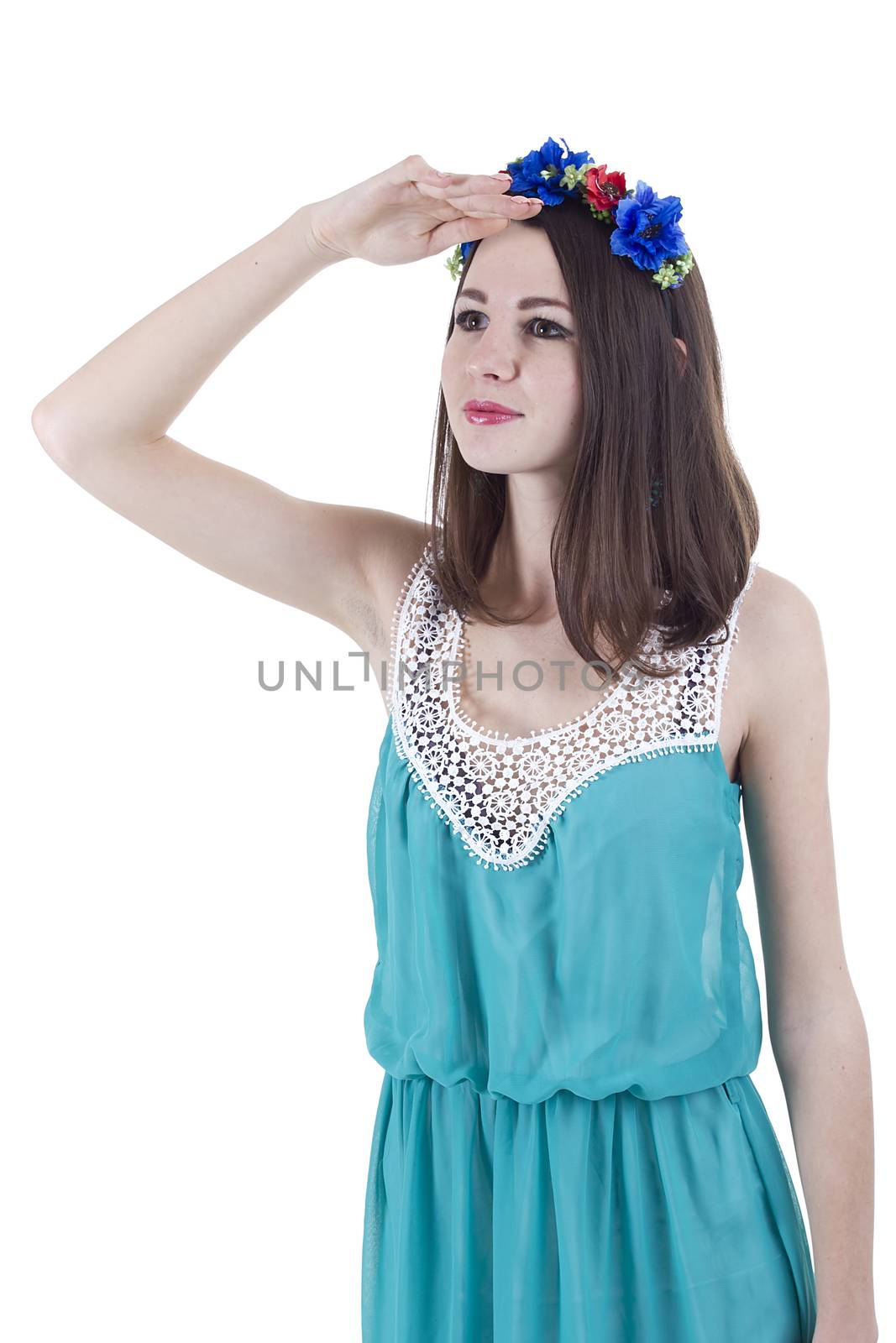 Portrait of a girl in a wreath of flowers on a white background