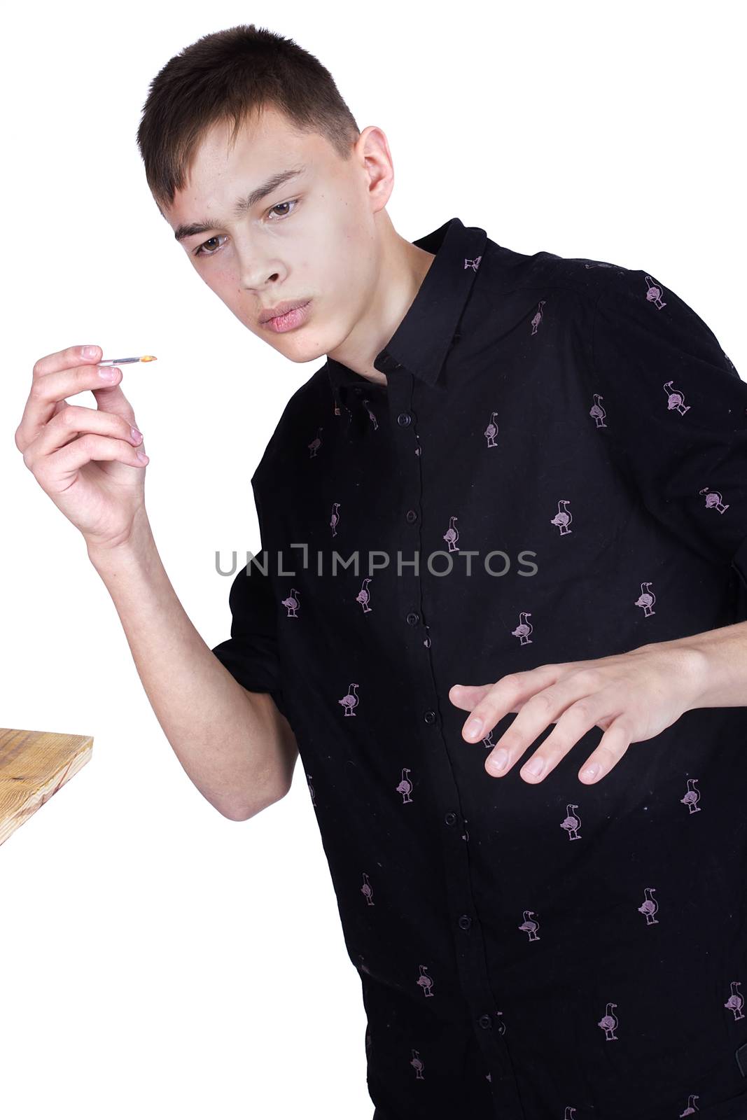 Young man makeup artist at work on a white background