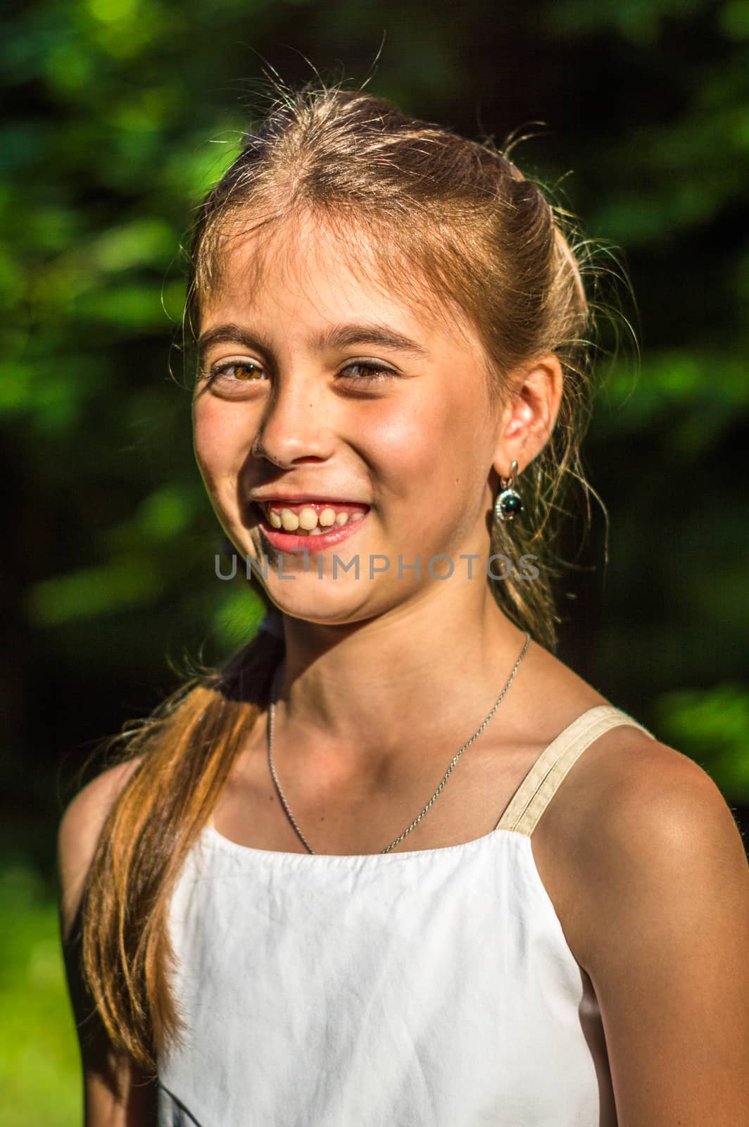 Portrait of a beautiful and happy girl in the Park