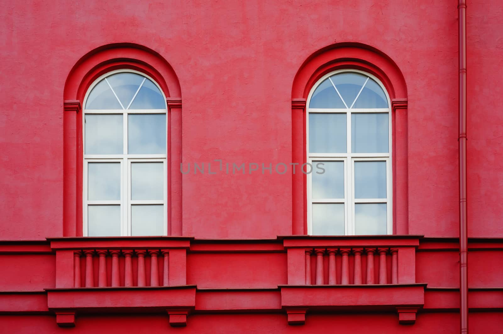 part of the multistory red houses with Windows and balcony.