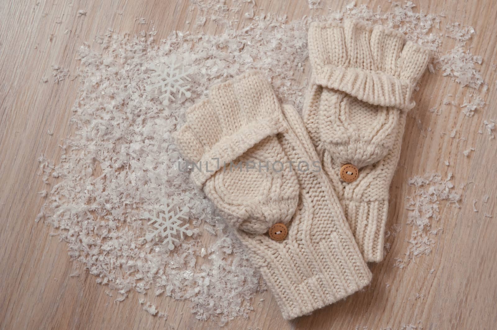 white knitted gloves and snow and place for text.
