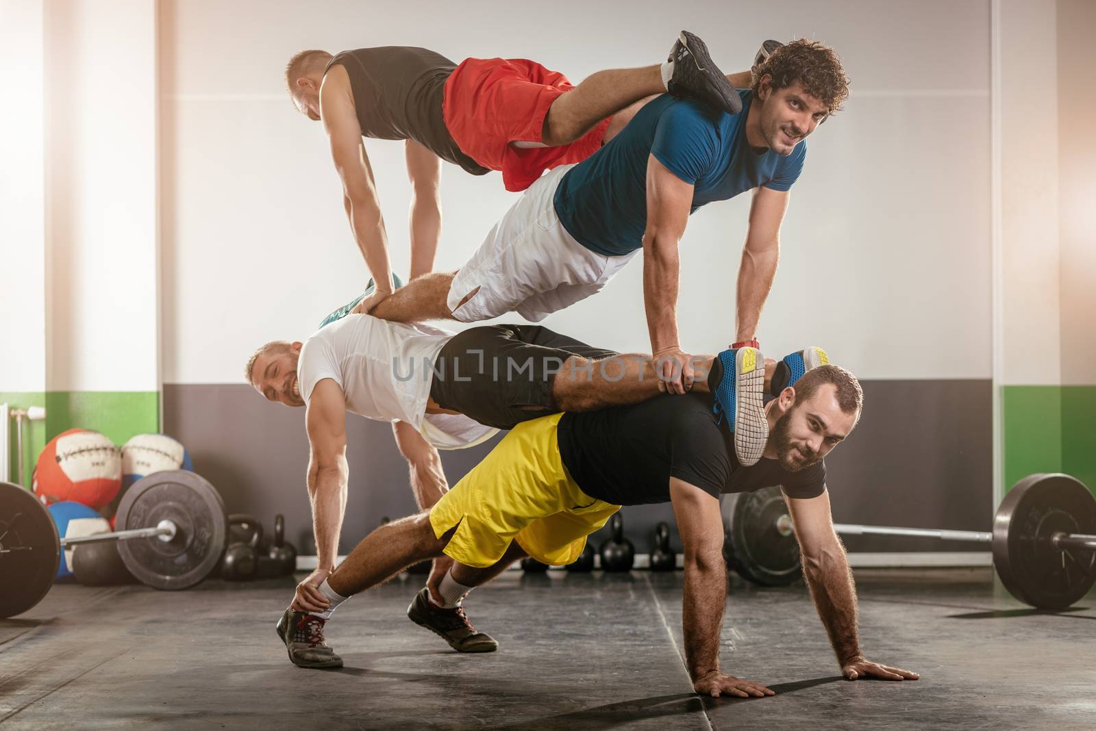 Group of young muscular man doing crossfit exercise at the gym.