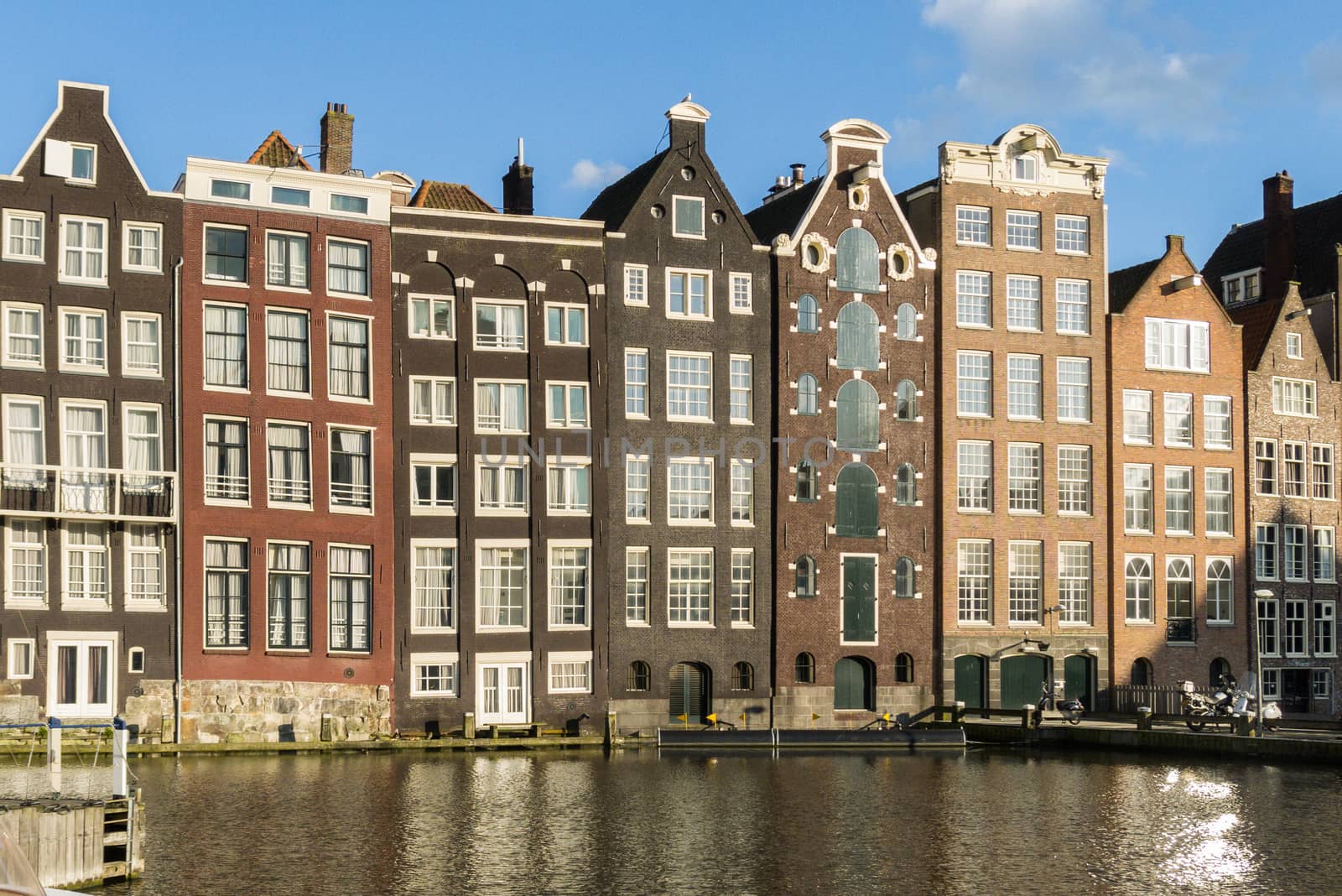 Houses in in a street by a canal in Amsterdam in the Netherlands