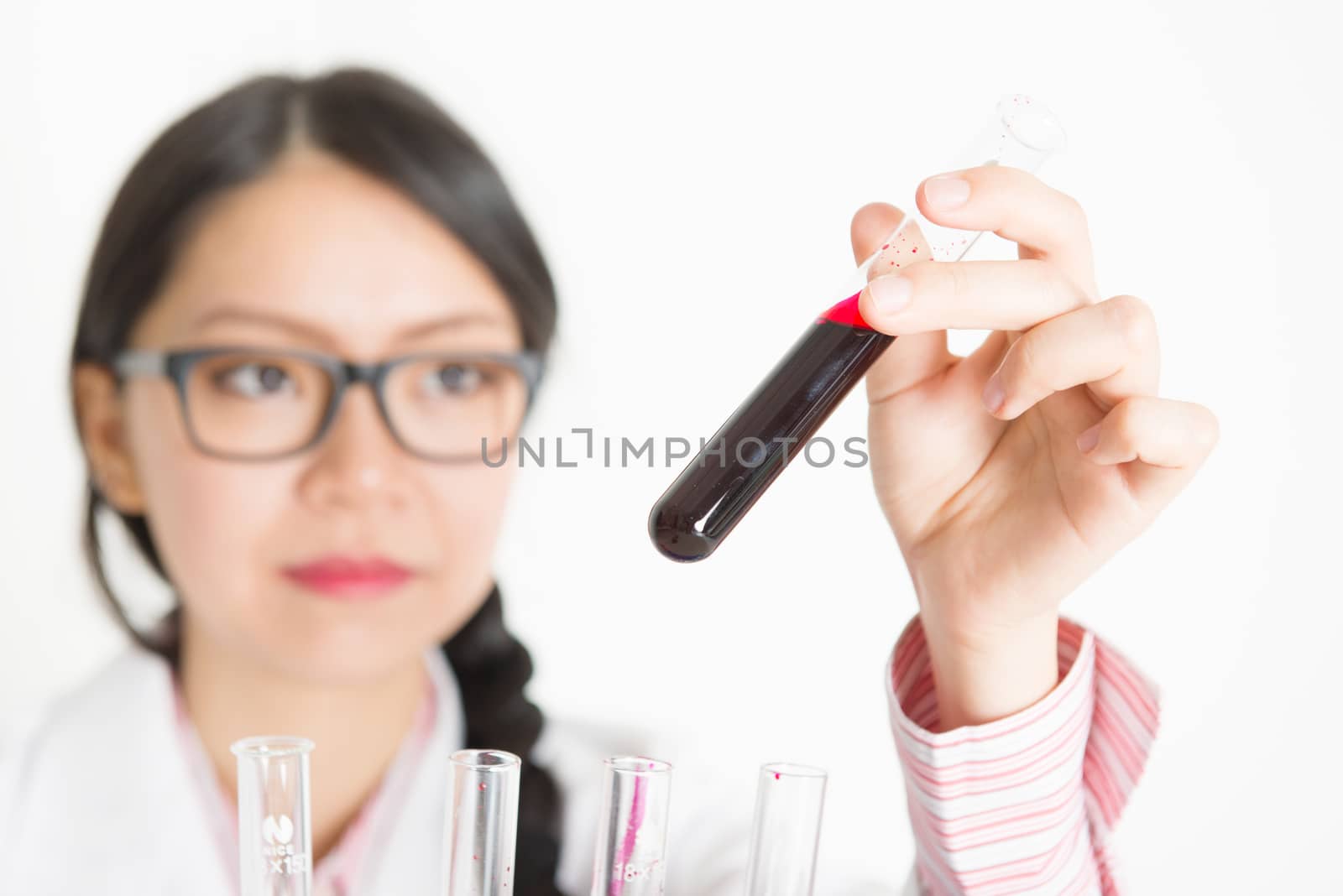 Young female scientist doing experiment by szefei